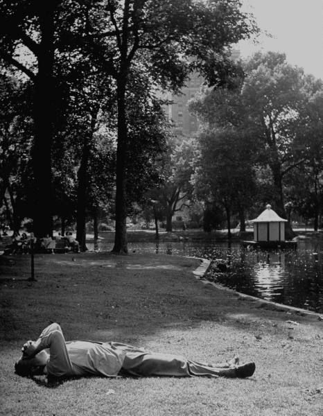 "Man lying on ground for cool place to relax." July 1951.